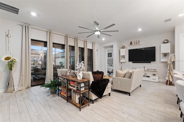 living room featuring ceiling fan and light wood-type flooring