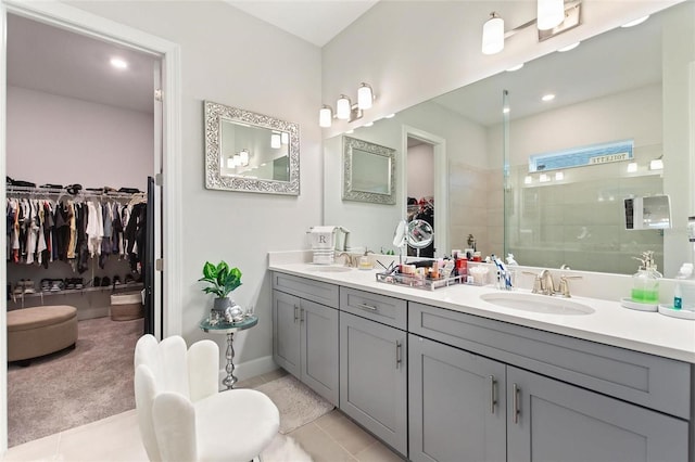 bathroom with tile patterned flooring, vanity, and walk in shower