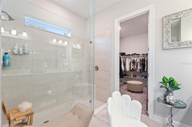 bathroom featuring tiled shower and tile patterned flooring