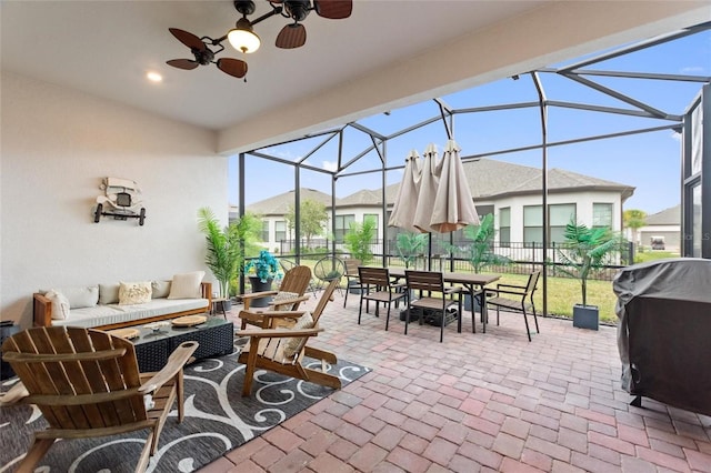 view of patio / terrace featuring area for grilling, a lanai, an outdoor hangout area, and ceiling fan