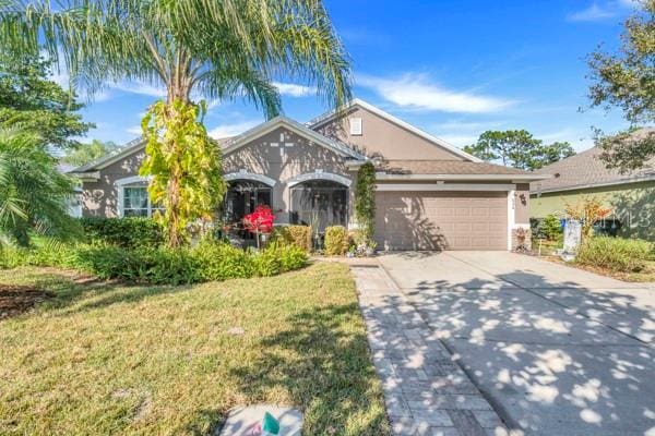 view of front of property with a garage and a front yard