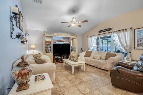 living room with lofted ceiling, tile patterned floors, and ceiling fan