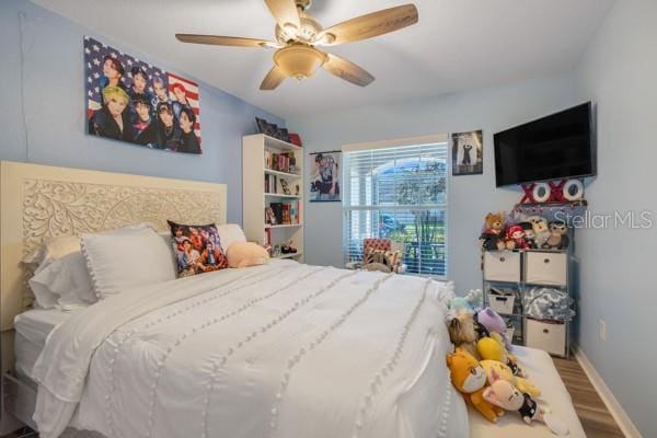 bedroom featuring hardwood / wood-style flooring and ceiling fan