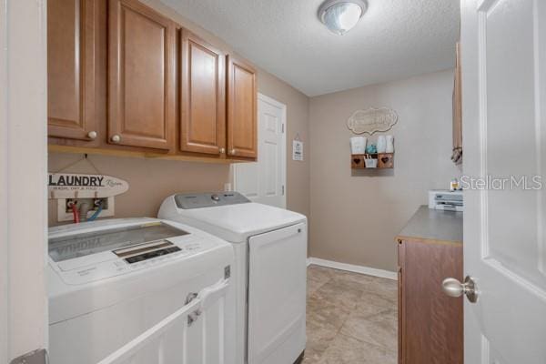 washroom featuring independent washer and dryer and cabinets