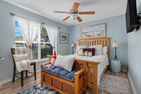 bedroom featuring light hardwood / wood-style flooring and ceiling fan