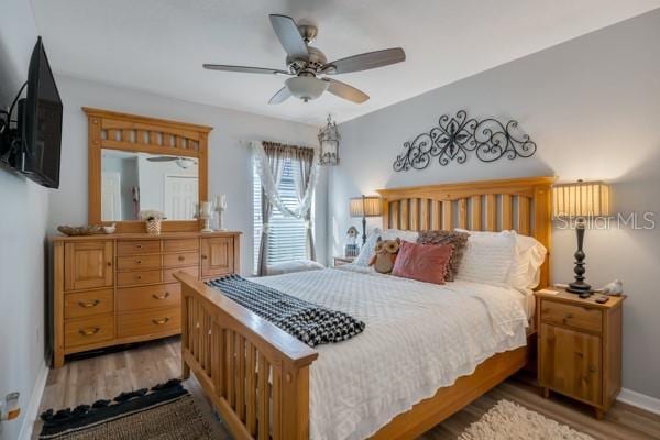 bedroom with ceiling fan and wood-type flooring