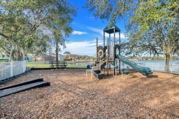 view of jungle gym with a water view