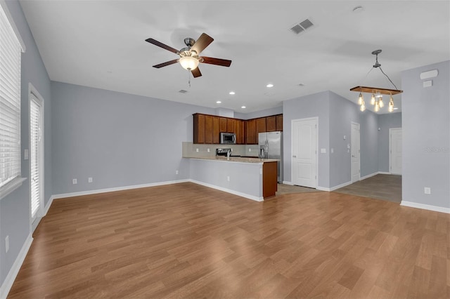 interior space featuring light hardwood / wood-style floors and ceiling fan