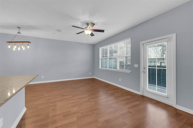 unfurnished living room with ceiling fan and light hardwood / wood-style flooring