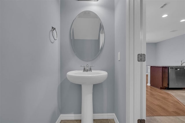 bathroom with hardwood / wood-style floors