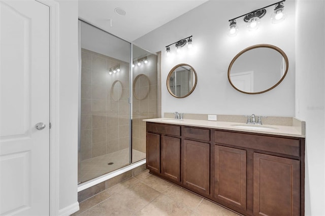 bathroom with tiled shower, tile patterned floors, and vanity