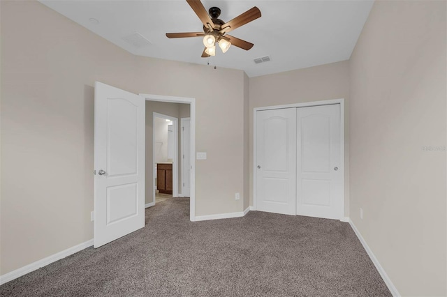 unfurnished bedroom featuring carpet, ceiling fan, and a closet