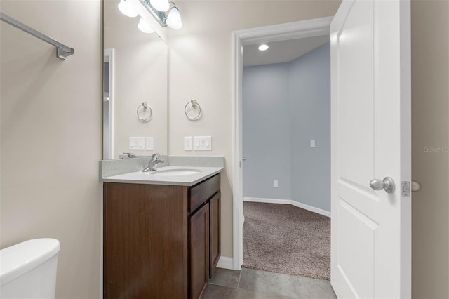 bathroom with vanity, tile patterned floors, and toilet