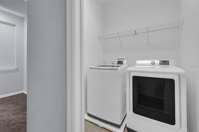 laundry room with washing machine and clothes dryer and carpet floors