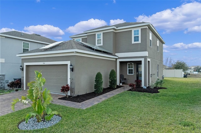 view of property with a garage and a front lawn