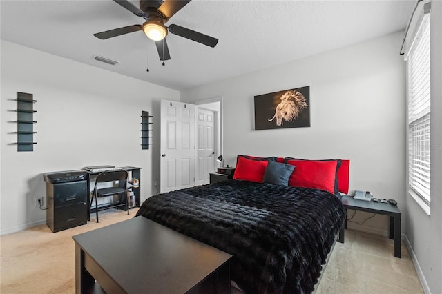 bedroom featuring ceiling fan and carpet