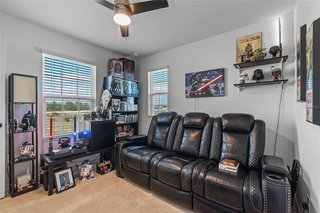 carpeted cinema featuring a textured ceiling and ceiling fan