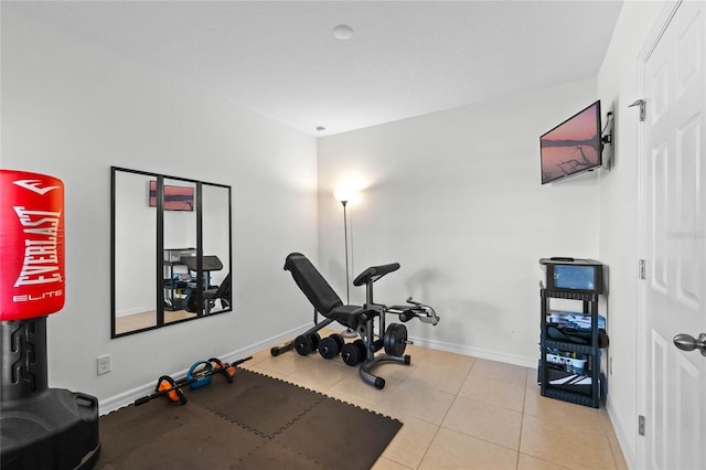 workout room featuring light tile patterned floors