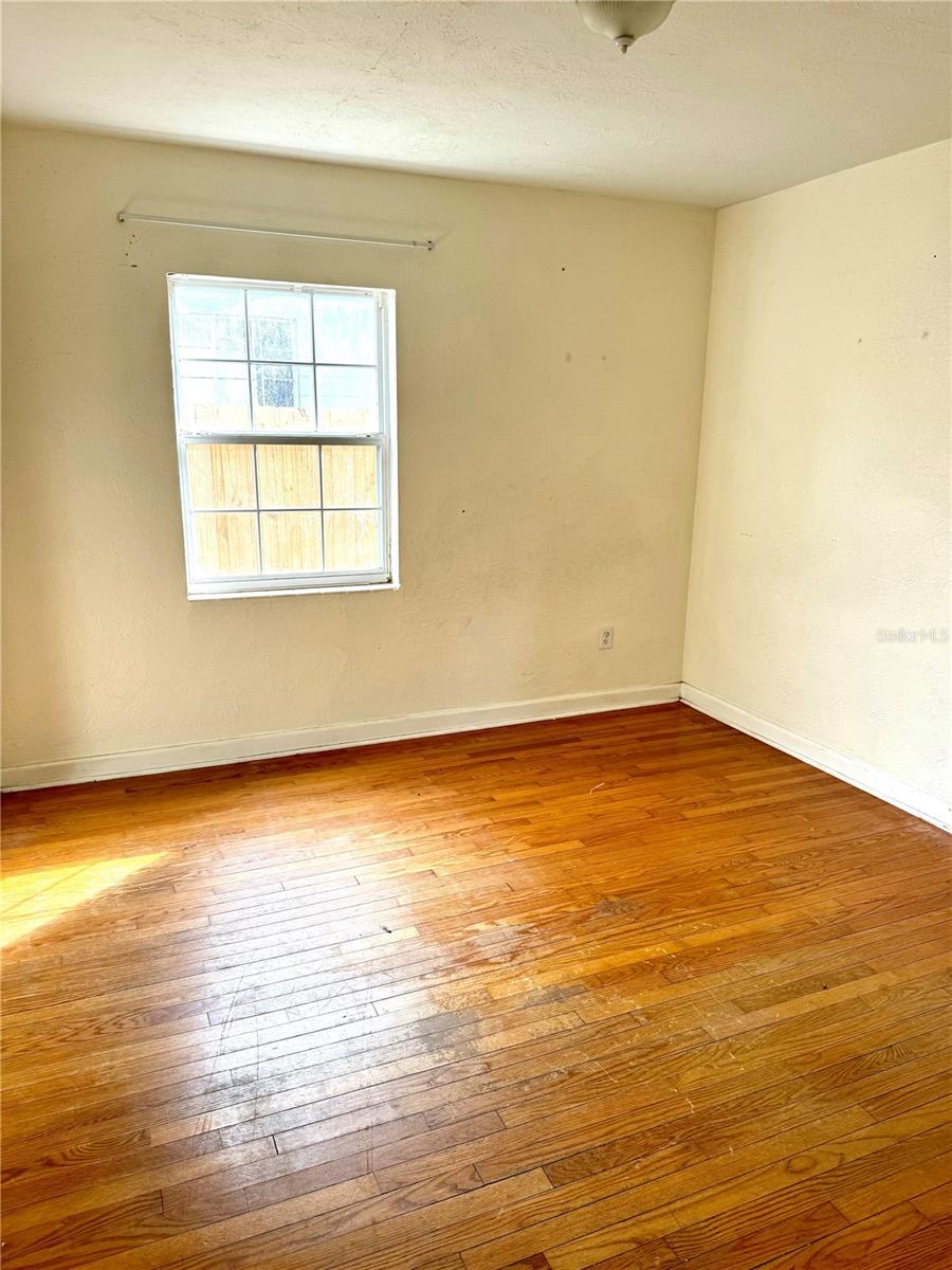 empty room with hardwood / wood-style flooring