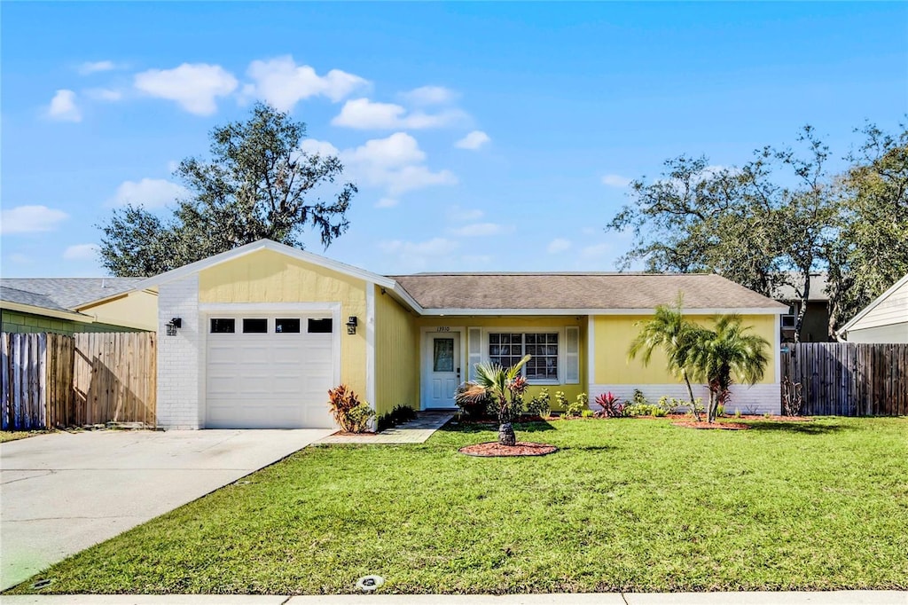 single story home with a garage and a front yard