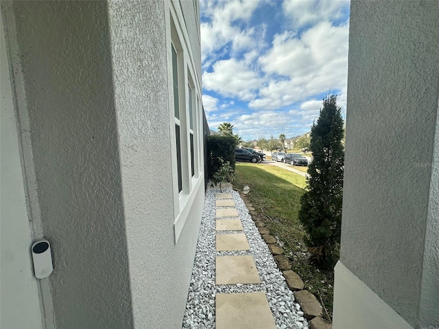 view of side of home with a lawn