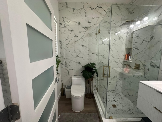 bathroom featuring a shower with door, vanity, hardwood / wood-style flooring, and toilet