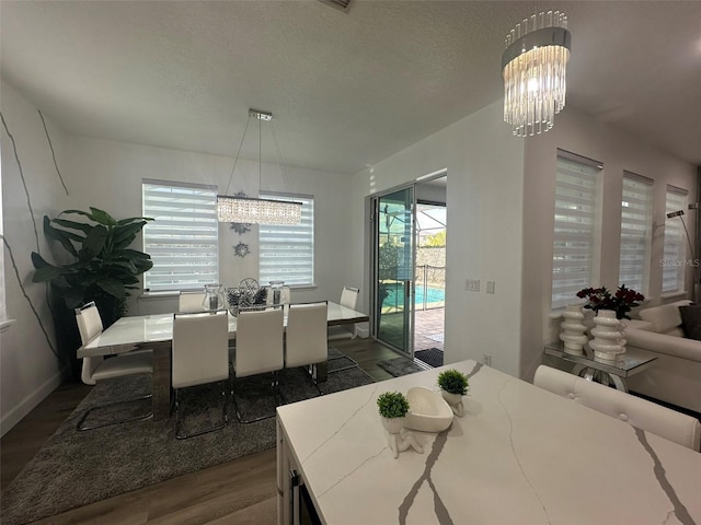 dining area featuring dark hardwood / wood-style floors and a chandelier