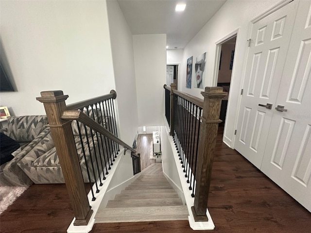 staircase with hardwood / wood-style floors