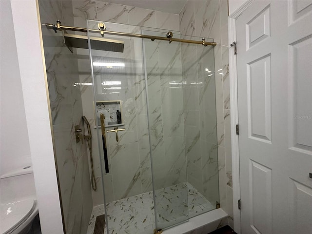 bathroom featuring a shower with door