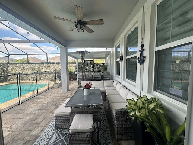 view of patio featuring ceiling fan, an outdoor hangout area, and a lanai