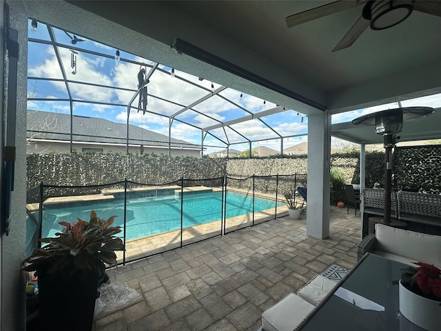 view of pool featuring a lanai, ceiling fan, and a patio area