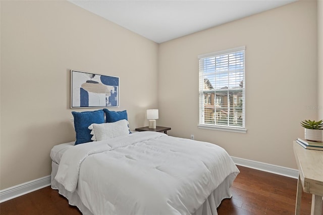 bedroom with dark hardwood / wood-style flooring