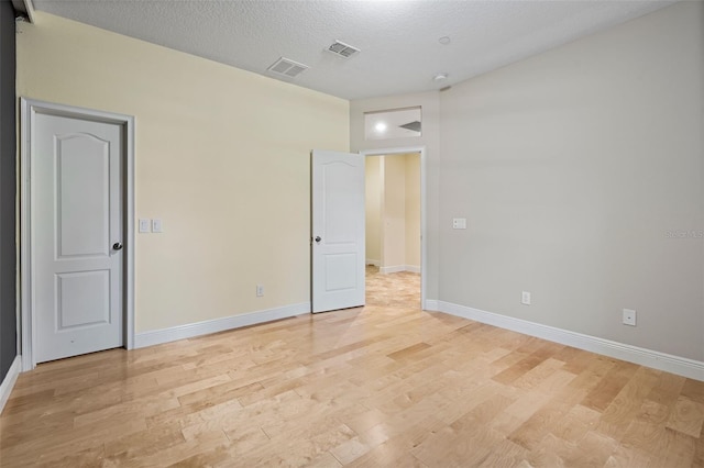 interior space with light hardwood / wood-style flooring and a textured ceiling