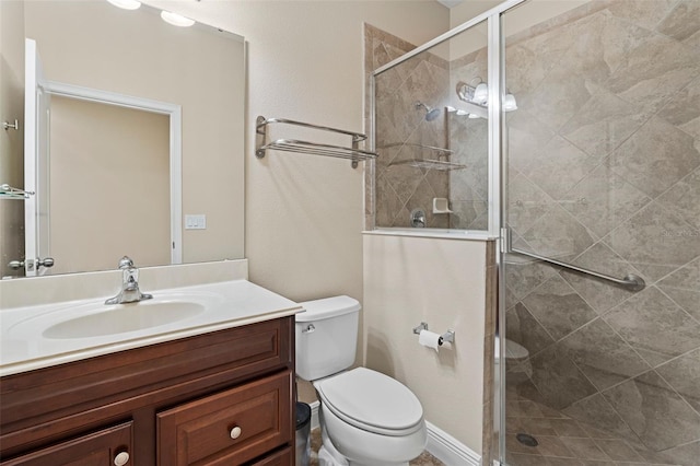 bathroom with vanity, an enclosed shower, and toilet