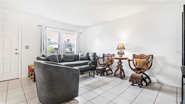 living room with a textured ceiling and light tile patterned floors