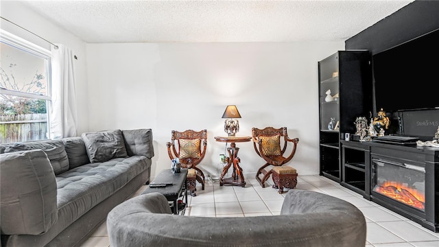 living room featuring a textured ceiling and light tile patterned flooring