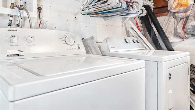 washroom featuring washing machine and dryer and tile walls