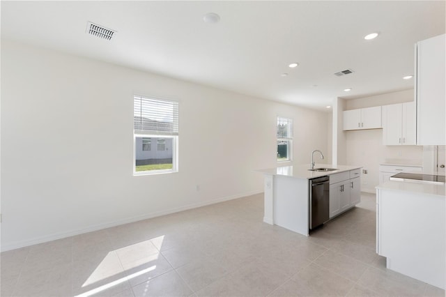 kitchen featuring sink, light tile patterned floors, dishwasher, an island with sink, and white cabinets