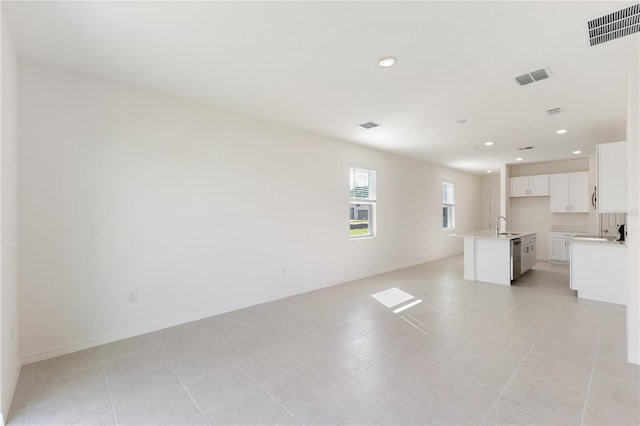 interior space featuring light tile patterned floors and sink