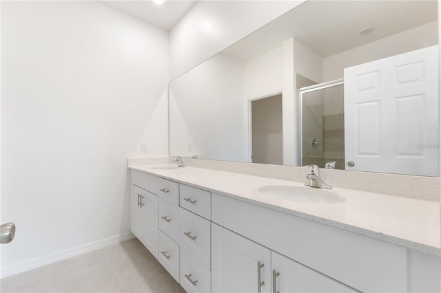 bathroom with vanity, tile patterned floors, and a shower with door