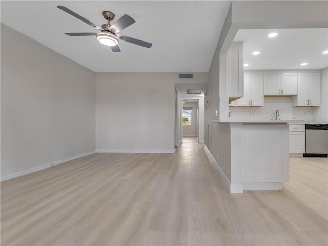 kitchen featuring dishwasher, white cabinets, backsplash, ceiling fan, and light hardwood / wood-style floors