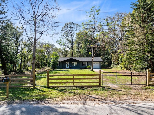 view of front of property with a garage and a front yard