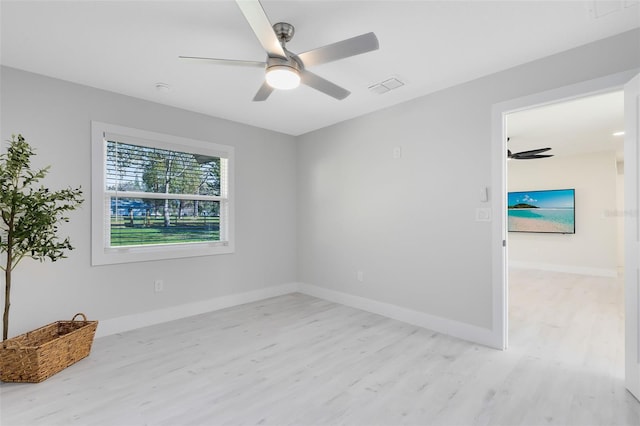 spare room with ceiling fan and light hardwood / wood-style floors