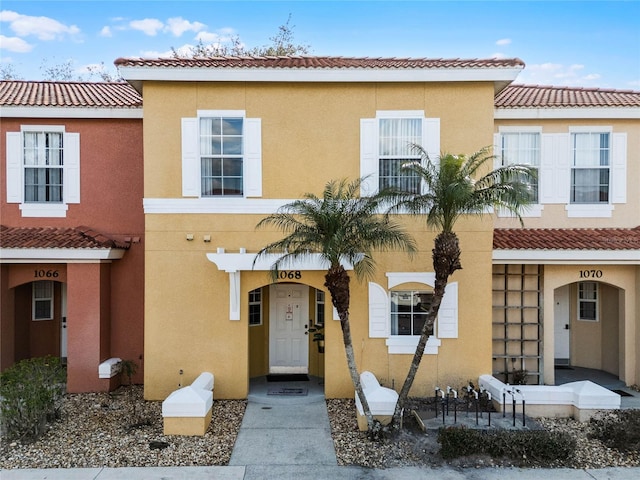 view of front of home featuring stucco siding and a tiled roof