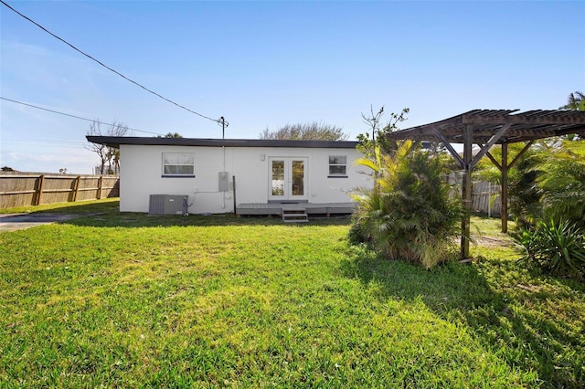 back of property featuring french doors, a yard, a pergola, and central air condition unit