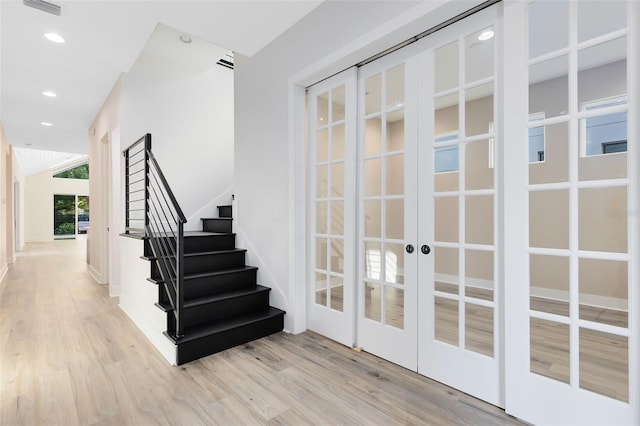 interior space with light hardwood / wood-style floors and french doors