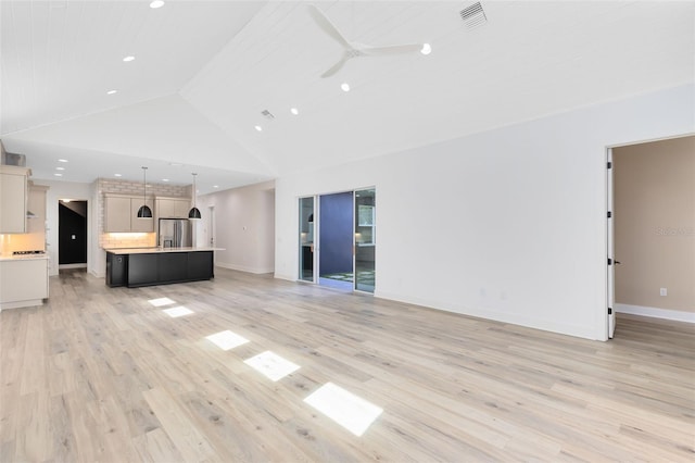 unfurnished living room featuring ceiling fan, light hardwood / wood-style floors, and high vaulted ceiling