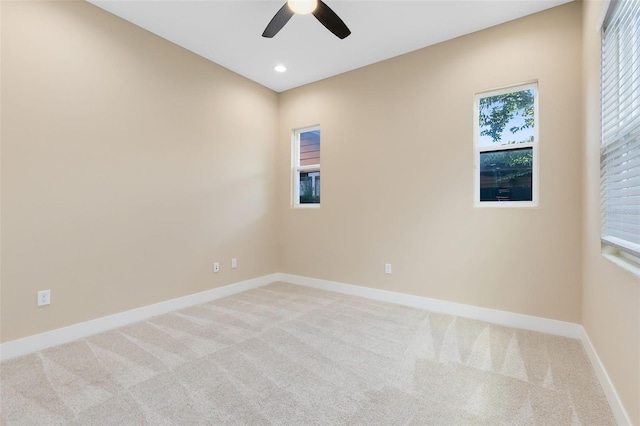 unfurnished room featuring light colored carpet and ceiling fan