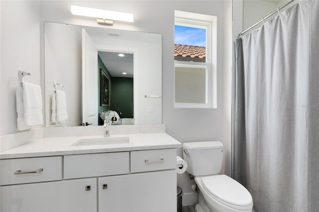 bathroom with vanity, toilet, and a shower with shower curtain