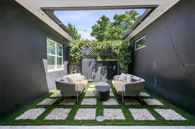 view of patio featuring fence and an outdoor hangout area